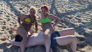 Smothering femdoms defeating male on the beach
